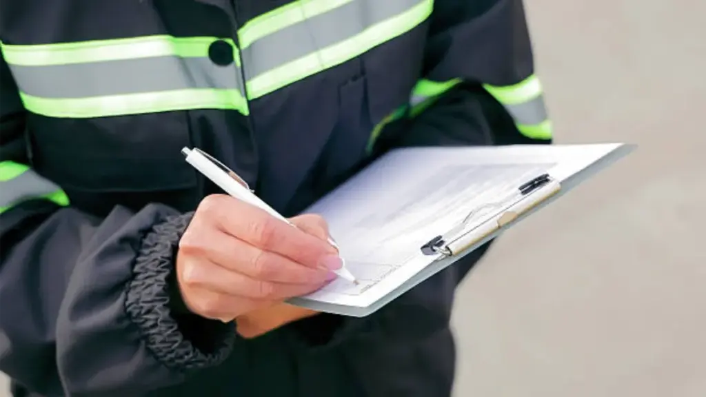 Worker Writing on Clipboard for Inspection.