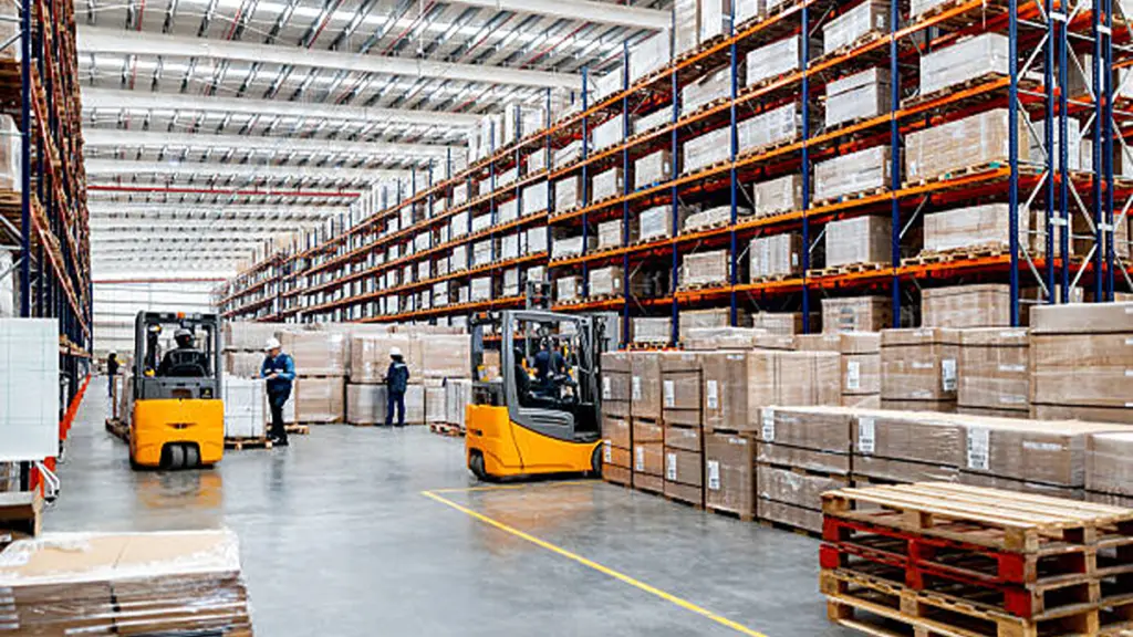 Employees working at an e commerce warehouse and using forklifts