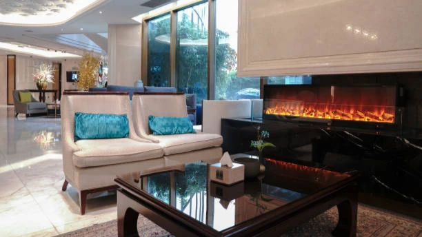 Electric fireplace with glowing flames in a modern hotel lobby with seating